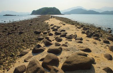 The tombolo walkway emerges at low tide on Sharp Island, one of Hong Kong's UNESCO Global Geoparks.