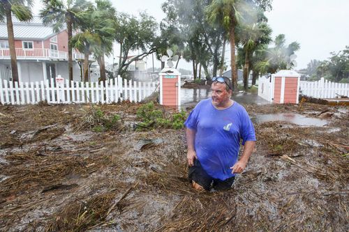 Daniel Dickert wades through water in front of his home where the Steinhatchee River overflowed on Wednesday, Aug. 30, 2023, in Steinhatchee, Fla., after the arrival of Hurricane Idalia.