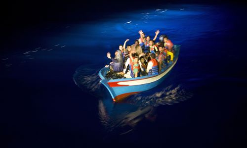 A wooden boat carrying migrants, not the boat mentioned in this story, attempts to cross into Europe.