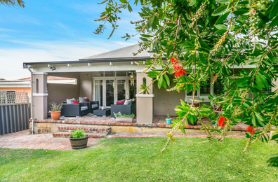Four-bedroom property is located  behind a "rendered brick front fence and sliding auto gate".