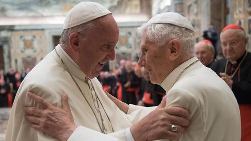 Pope Francis, left, and retired Pope Benedict XVI embrace during a ceremony to celebrate Benedict's 65th anniversary of his ordination as a priest