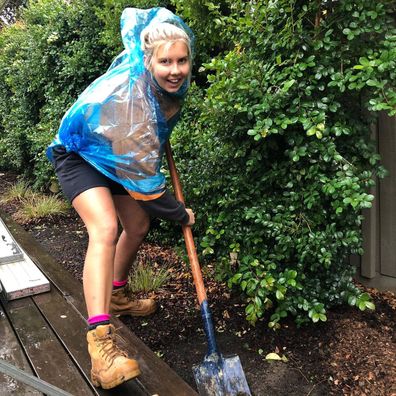 Aimee Stanton digging a hole on a job site.