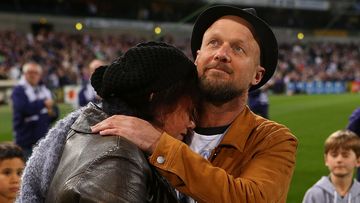 Parents of MH17 crash victims Evie, Mo and Otis Maslin, Rin Norris is comforted by Anthony Maslin after releasing balloons before the round 19 AFL match between the Fremantle Dockers and the Carlton. (Getty)