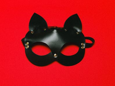 Stock image of a leather mask and nipple covers.
