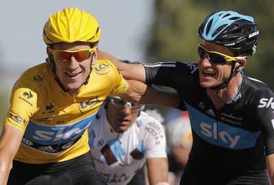 Rogers celebrates with victorious teammate Brad Wiggins in the 2012 Tour de France. (AAP)