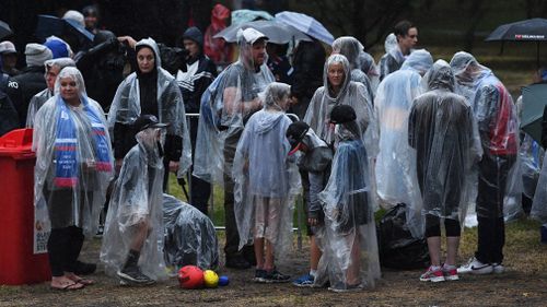 People are seen outside of Princes Park ahead of the AFLW grand final in Carlton North. (AAP)