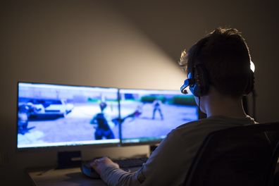 Young boy playing games on a computer at home