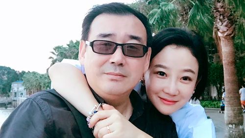 Yang Hengjun, left, poses with a family member in Beijing. Australia's Foreign Minister Marise Payne said  her government was "deeply disappointed" that the Chinese-Australian writer was placed in criminal detention in Beijing six months after he was taken into custody at a Chinese airport.