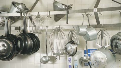 Hang the pans you use the most on a stainless steel rail near your stove (Thinkstock)