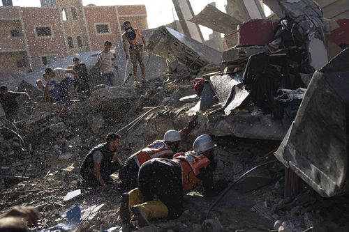 Palestinians look for survivors after an Israeli airstrike on Khan Younis, Gaza Strip, Tuesday, Oct. 17, 2023.