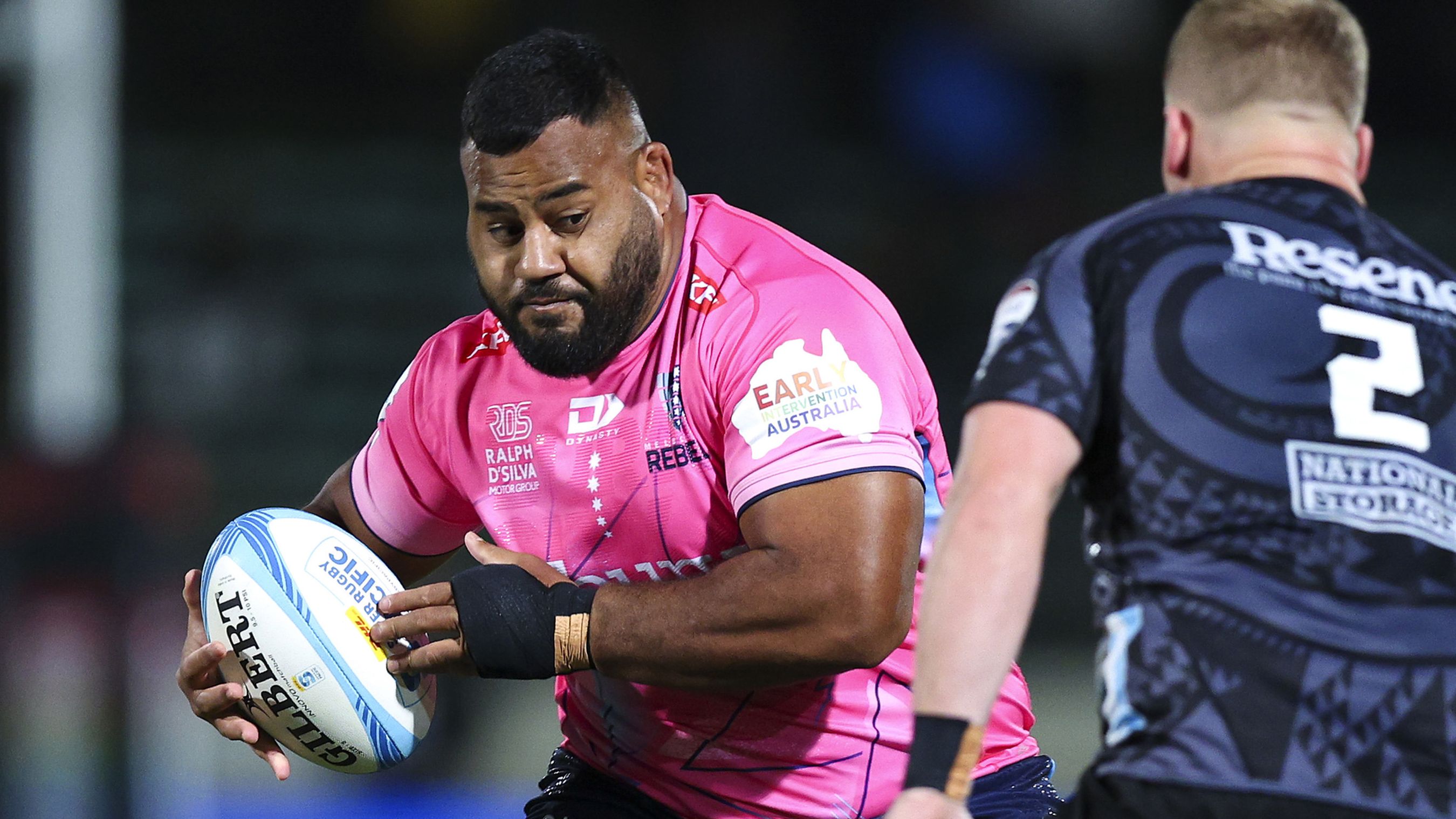 Taniela Tupou of the Rebels attempts to evade James O&#x27;Reilly of the Hurricanes.