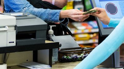 Mother paying for groceries