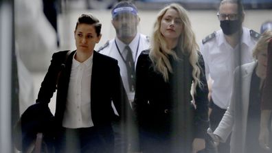 American actress Amber Heard arrives with her girlfriend Bianca Butti, left, at the High Court in London, Tuesday, July 28, 2020