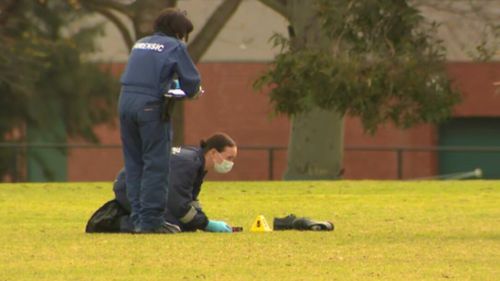 Detectives photographs a pair of shoes, which were found near Ms Dixon's body on Wednesday morning. (9NEWS)