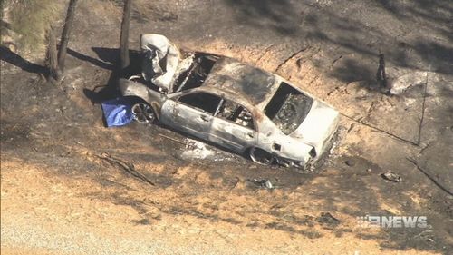 A bushfire was sparked when the car burst into flames. (9NEWS)