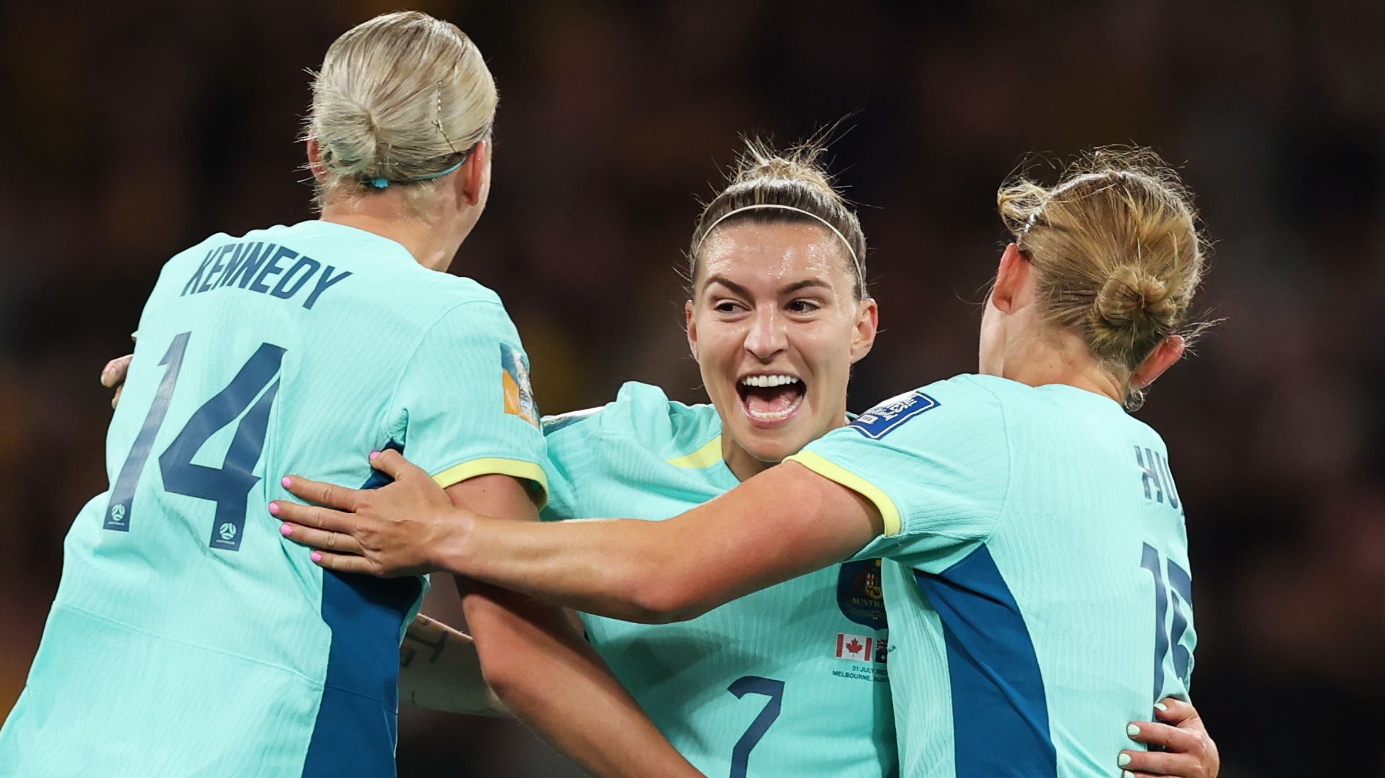 MELBOURNE, AUSTRALIA - JULY 31: Hayley Raso (C) of Australia celebrates with teammates Alanna Kennedy (L) and Clare Hunt (R) after scoring her team&#x27;s first goal during the FIFA Women&#x27;s World Cup Australia &amp; New Zealand 2023 Group B match between Canada and Australia at Melbourne Rectangular Stadium on July 31, 2023 in Melbourne, Australia. (Photo by Alex Pantling - FIFA/FIFA via Getty Images)