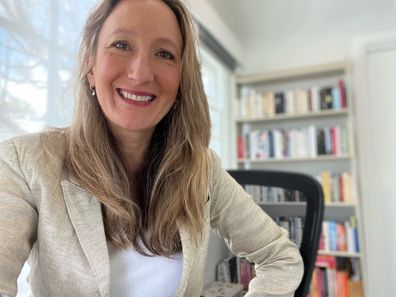 Melanie Greblo smiles in her office.