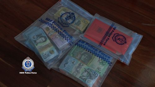 Two people have been charged over an alleged money laundering scheme involving damaged Australian coins.