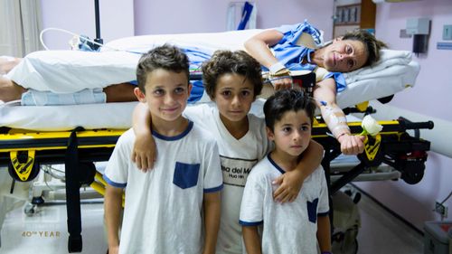 Sam in hospital with her three boys.