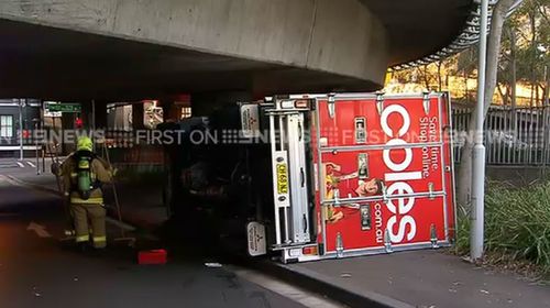 Coles driver ‘follows GPS’ and flips truck on Sydney road