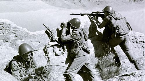 In this late April 1988, file photo, Soviet soldiers observe the highlands, while fighting guerrillas at an undisclosed location in Afghanistan.