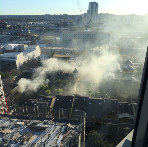 Smoke poured out of the apartment building. (Scott Koenig)