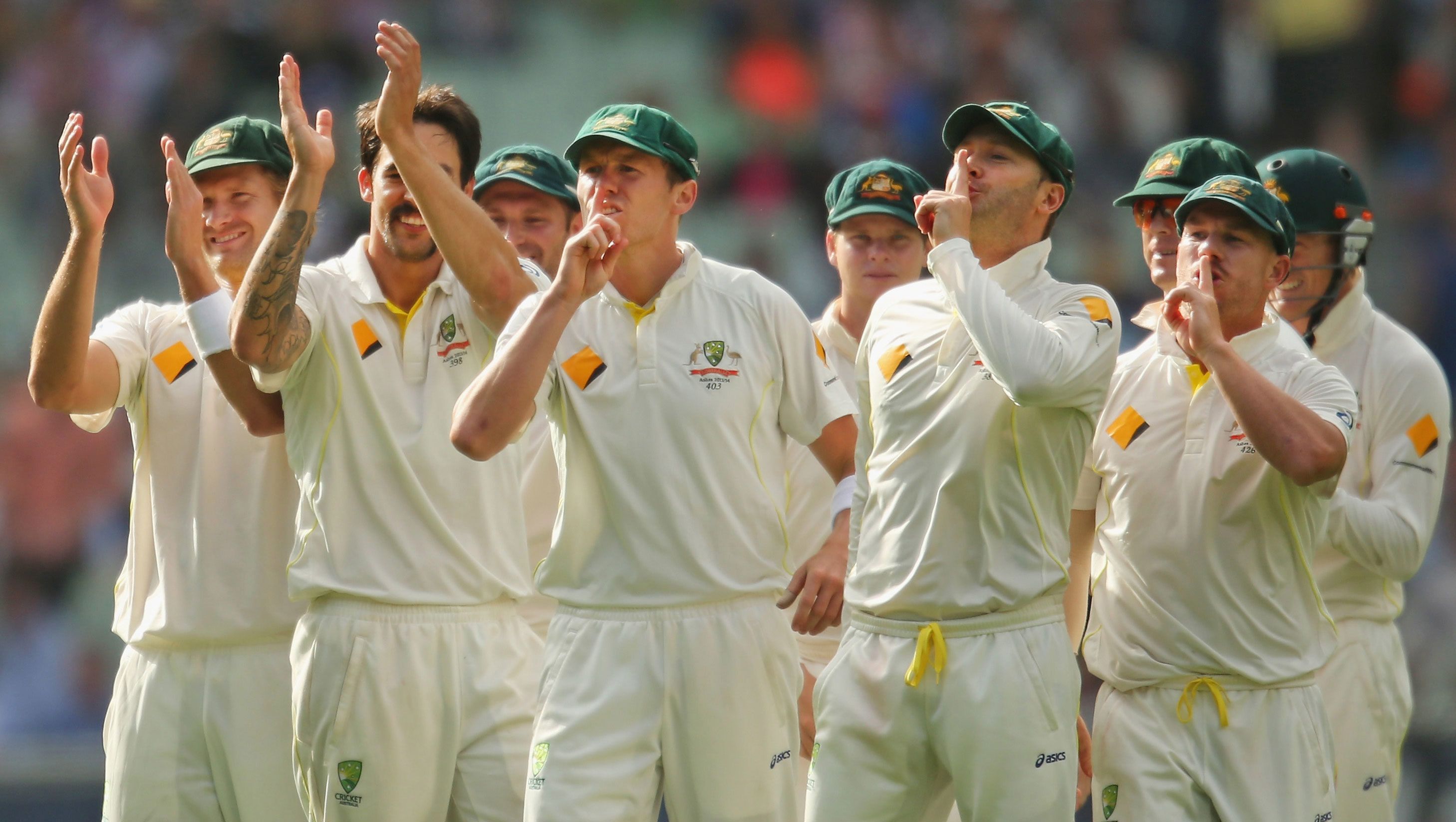Mitchell Johnson (second from left) applauds as David Warner (far right) and teammates shoosh the Barmy Army during the 2013 Ashes series.