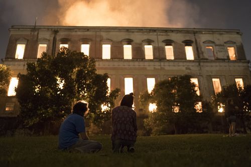 People watch as flames engulf the 200-year-old National Museum of Brazil. 