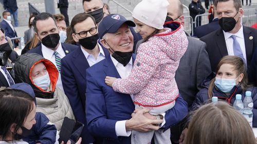 President Joe Biden meets with Ukrainian refugees during a visit to PGE Narodowy Stadium, Saturday, in Warsaw. 