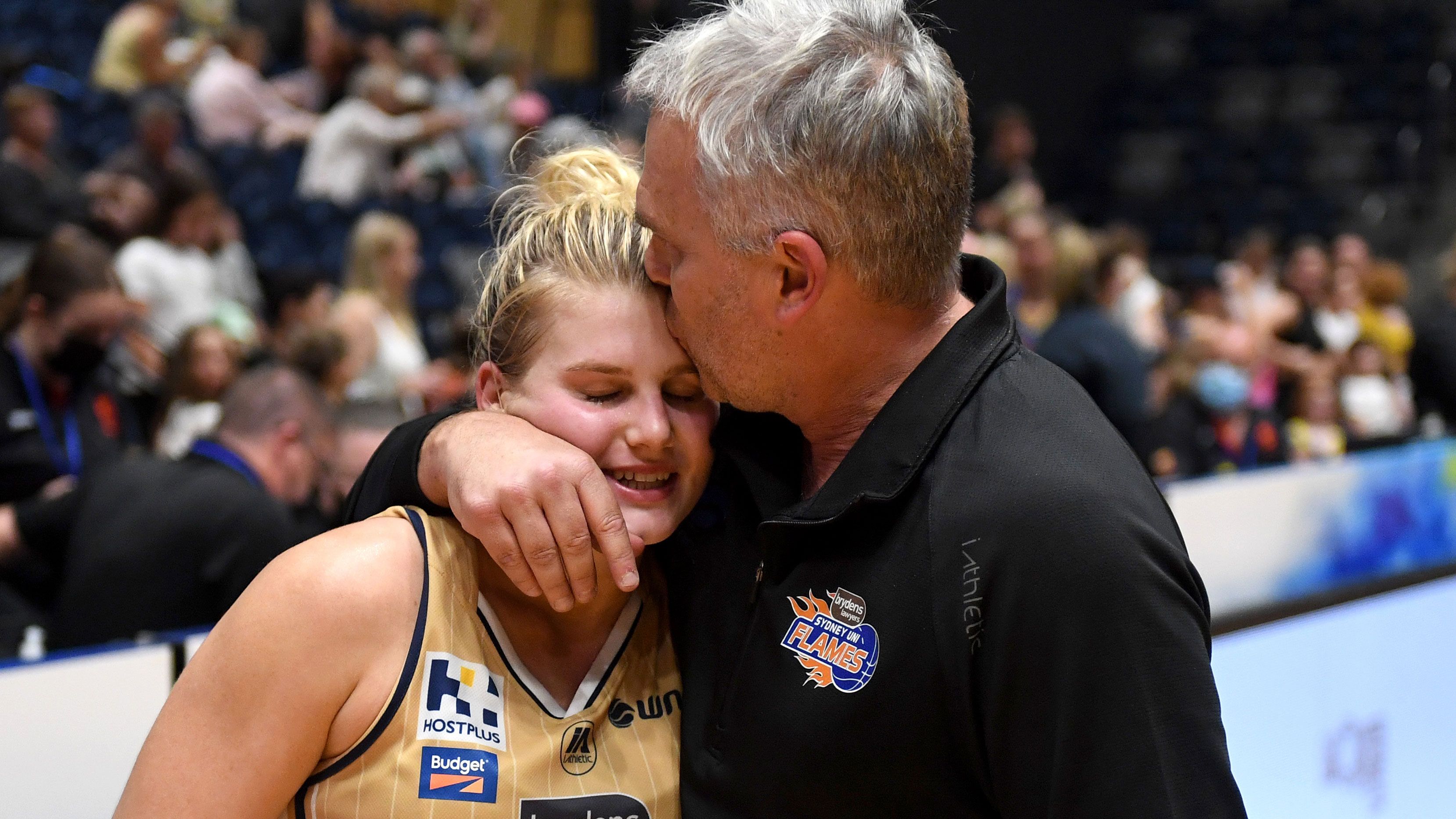 Shyla Heal of the Flames is embraced by her father and head coach, Shane Heal. 