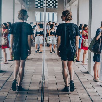 Man looking in mirror, walking