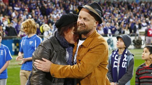 Rin Norris (left) and Anthony Maslin parents of Mo, Evie and Otis seen during a tribute to their children prior to the start of the Round 19 AFL match in Perth, 2014.