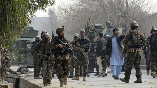 Afghan security forces patrol the site of an attack on a Save the Children office. Photo: AP