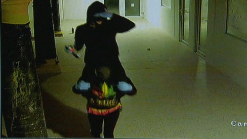 The girls cover their faces as the approach the security camera. (9NEWS)