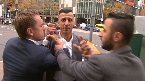 The man, understood to be Ivan Maqi's brother, is held back during the scuffle. (9NEWS)