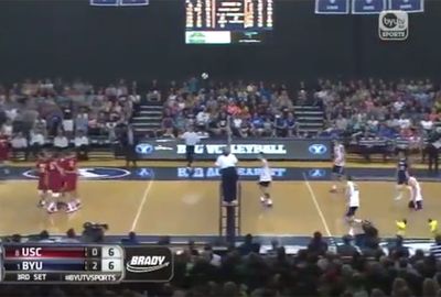 A volleyball team celebrates as a ball approaches. Watch the video..