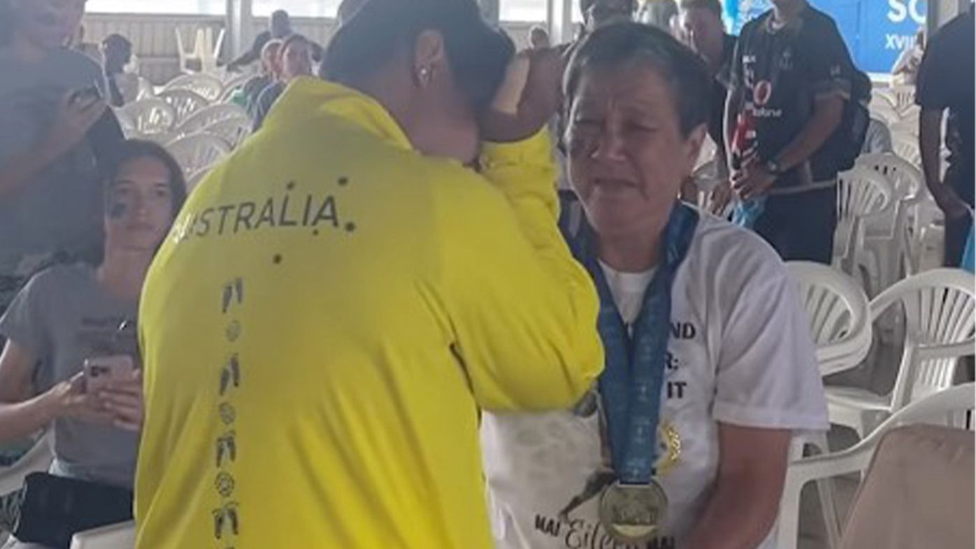 Australian weightlifter Eileen Cikamatana embraces family after winning a gold medal at the 2023 Pacific Games in the Solomon Islands.