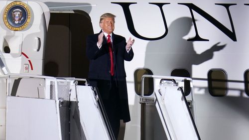 Supporters cheer as President Donald Trump arrives for a campaign rally at John P. Murtha Johnstown-Cambria County Airport in Johnstown, PA.