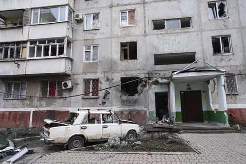 An apartment building damaged following a rocket attack on the city of Mariupol, Ukraine, Friday, Feb. 25, 2022. 