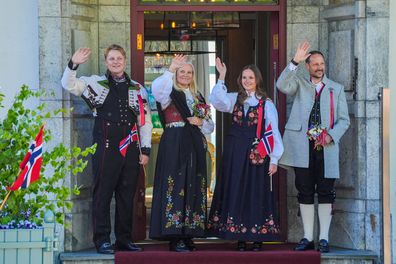 Norway's Crown Prince Haakon, Crown Princess Mette-Marit and their children Prince Sverre Magnus, left, and Princess Ingrid Alexandra, second left, greet the children's procession during the May 17 celebration at Skaugum in Asker, Norway, Saturday May 17, 2025. (Lise Aaserud/NTB via AP)