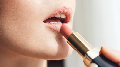 Make-up makeup cosmetics lipstick woman applying lip gloss