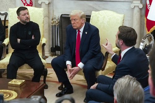 Vice President JD Vance, right, speaks with Ukrainian President Volodymyr Zelenskyy, left, as President Donald Trump listens in the Oval Office at the White House on February 28. 2025.
