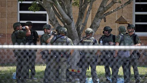  Law enforcement personnel stand outside Robb Elementary School following a shooting, May 24, 2022, in Uvalde, Texas. 