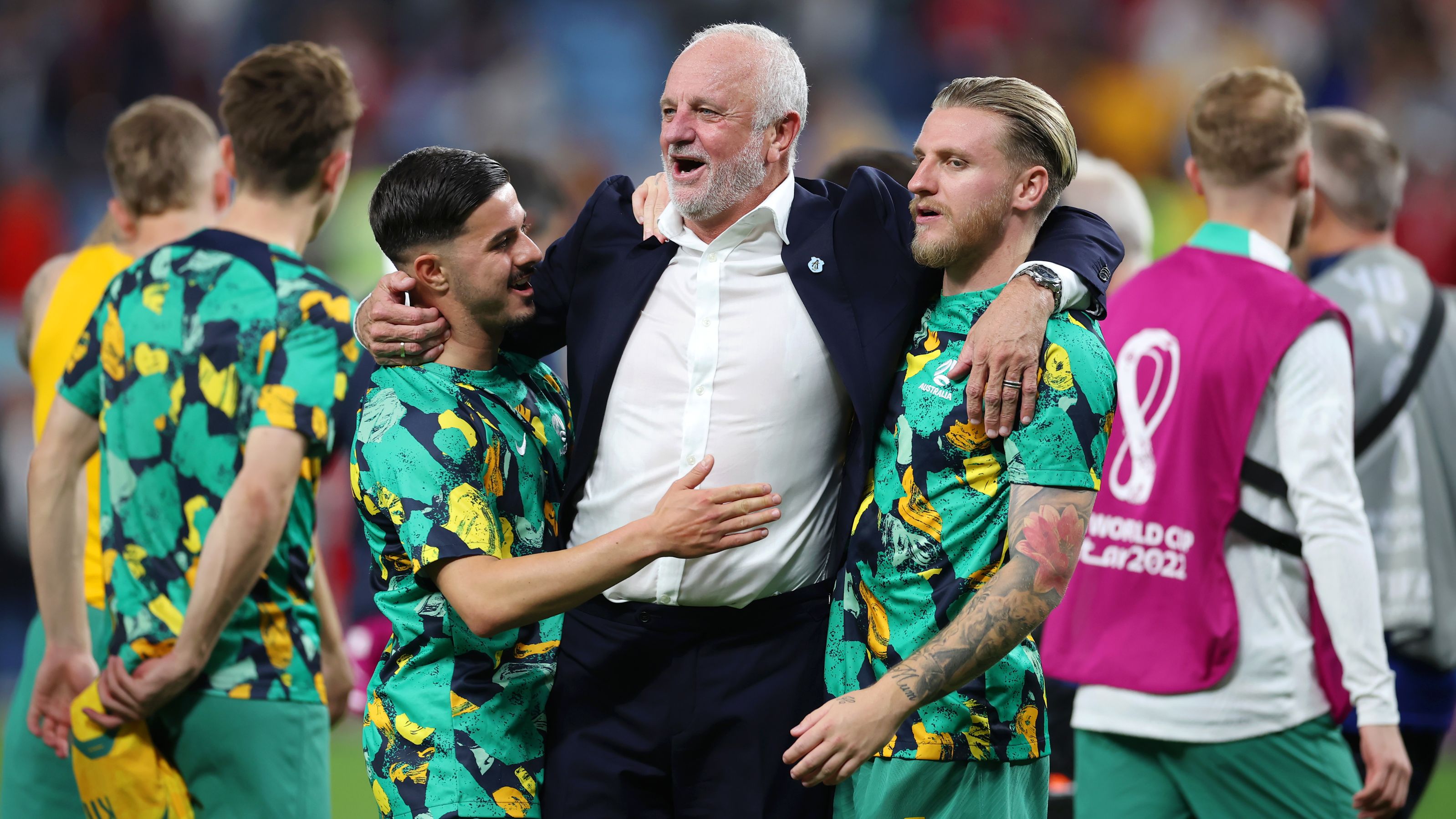 Graham Arnold is congratulated by his players after their 1-0 victory.