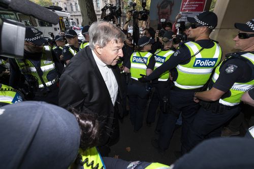 George Pell arrives at court to learn whether he will stand trial. 