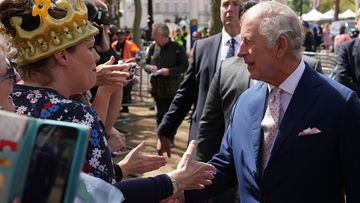 King Charles III greets members of the public along the Mall as preparations continue for The Coronation on May 5, 2023 in London