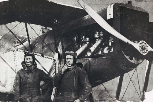 Sir Charles Kingsford Smith and Charles Ulm standing next to their plane after their arrival in England, 1929.