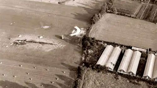 The spot in the greenhouse where the pilot crashed through is visible in this photo.