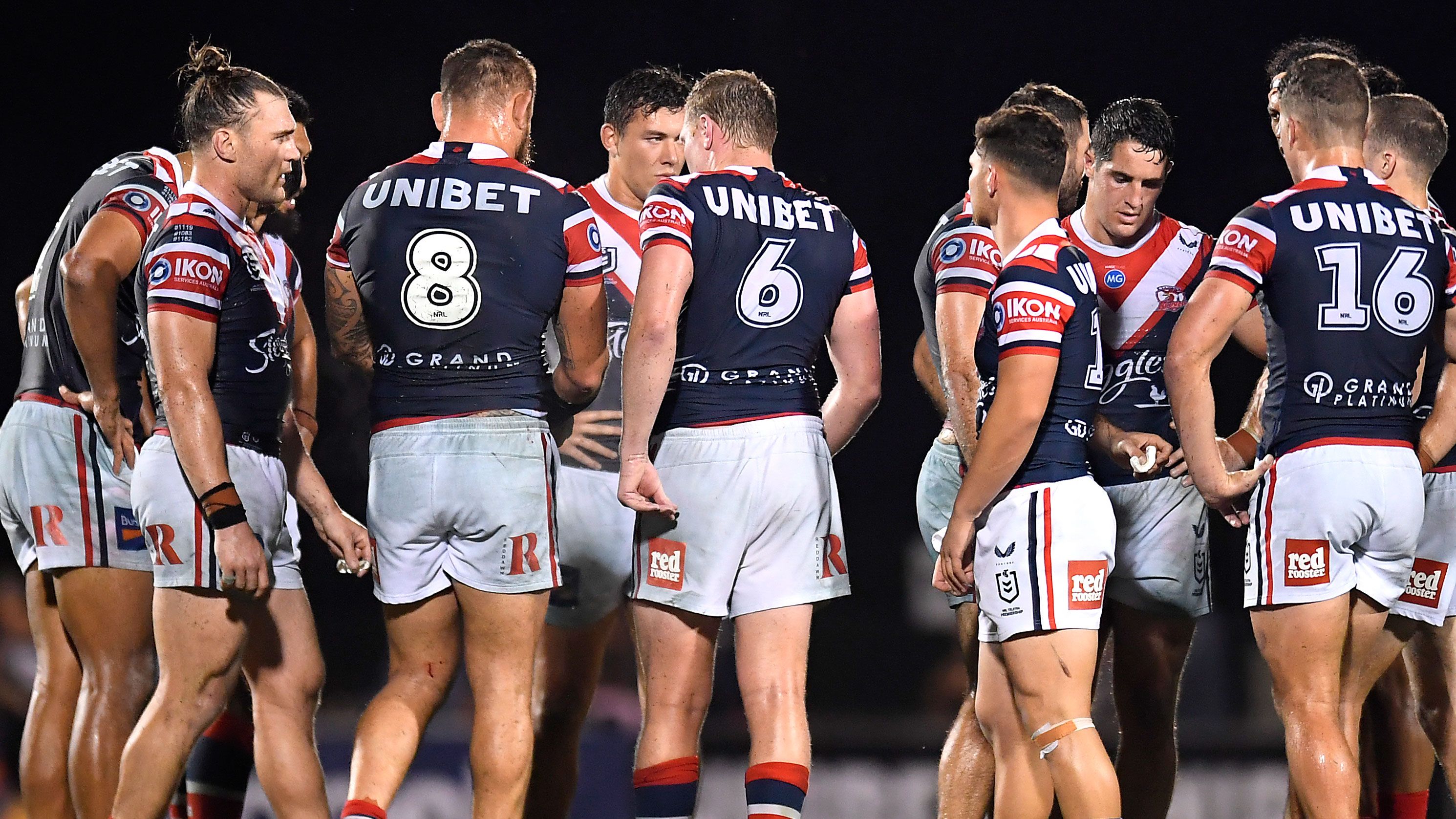 Sydney Roosters players congregate after conceding a try.