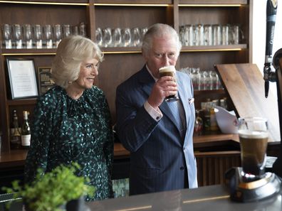 The Prince of Wales sips Guinness during a visit with Camilla, Duchess of Cornwall to the Irish Cultural Centre to celebrate the Centre's 25th anniversary in the run-up to St Patrick's Day 